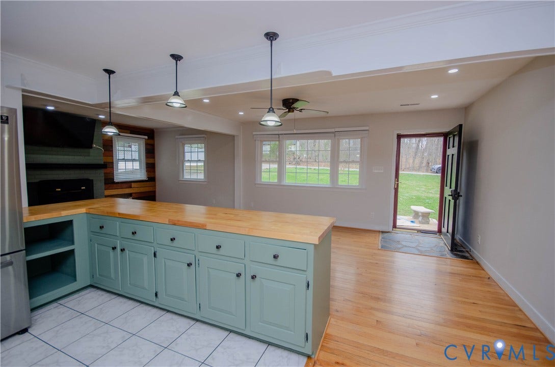 2231 Fall Line Drive, Powhatan, VA 23139 Kitchen with butcher block countertops, open floor plan, pendant lighting, freestanding refrigerator, and ceiling fan