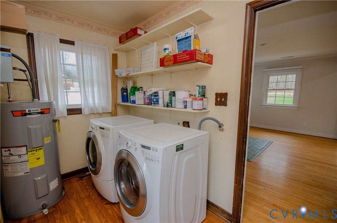 2231 Fall Line Drive, Powhatan, VA 23139 Laundry area featuring light wood finished floors, water heater, washing machine and clothes dryer, and healthy amount of natural light