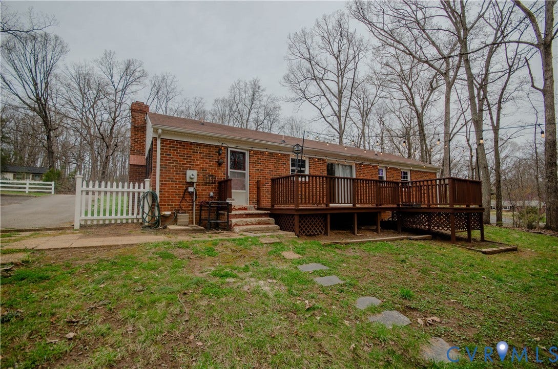 2231 Fall Line Drive, Powhatan, VA 23139 Rear view of house featuring a chimney, brick siding, and a deck