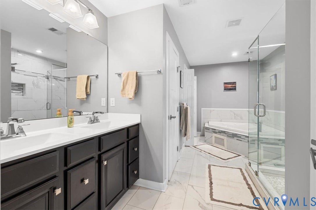 10448 Centralia Station Road, Chesterfield, VA 23831 Primary bathroom with double vanity, glass enclosed shower and garden tub