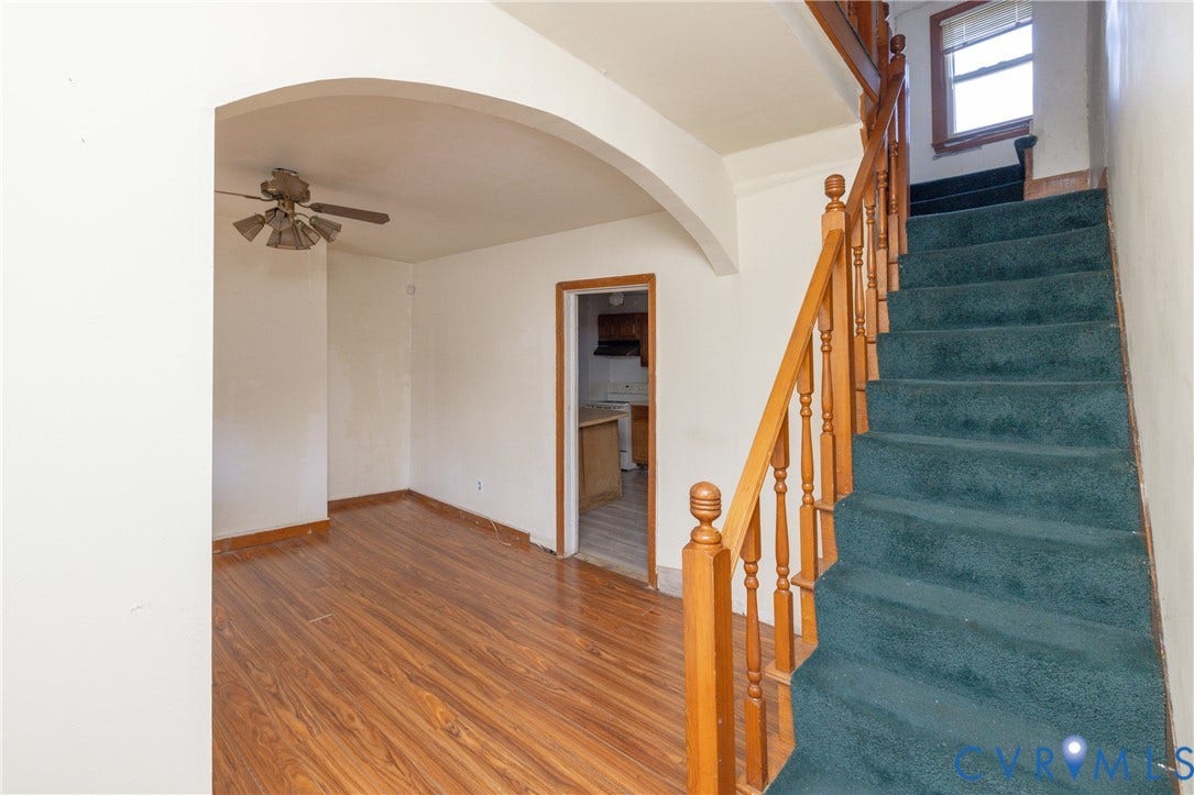 2606 Cedar Street, Richmond, VA 23223 Stairs featuring arched walkways, wood finished floors, and a ceiling fan