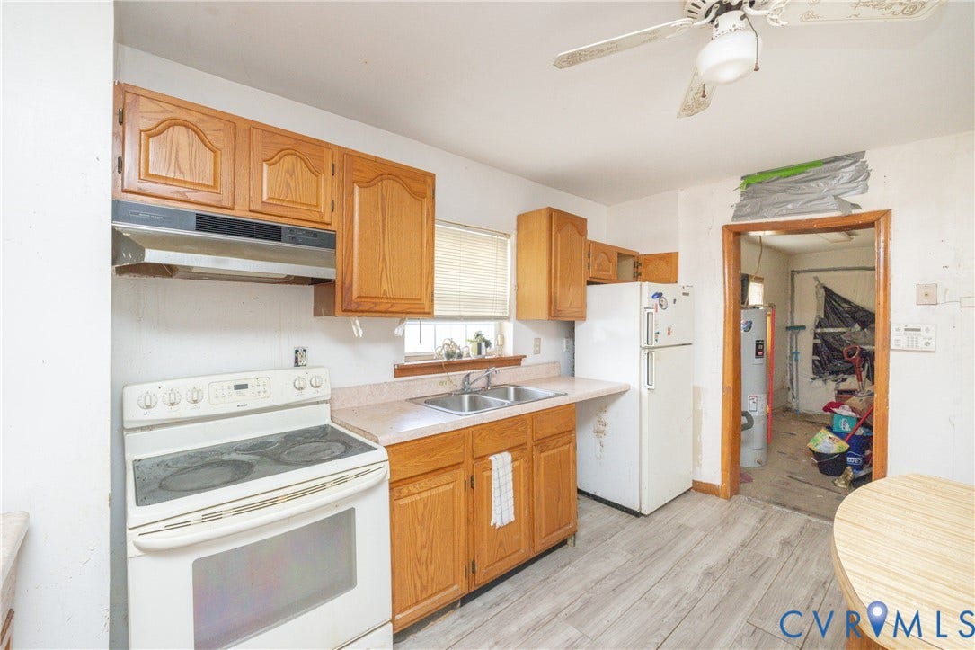 2606 Cedar Street, Richmond, VA 23223 Kitchen with white appliances, light countertops, a ceiling fan, light wood-style floors, and wood finish cabinets