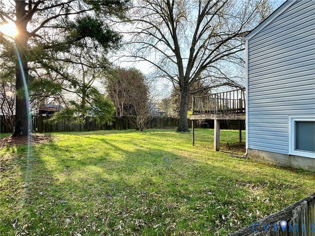 Fenced backyard featuring a wooden deck