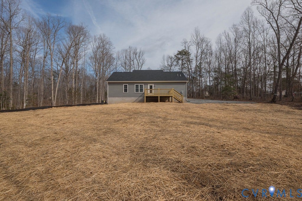 1164 Jefferson Highway, Moseley Estates, Louisa, VA 23093 Back of house with a wooden deck, stairs, and a yard