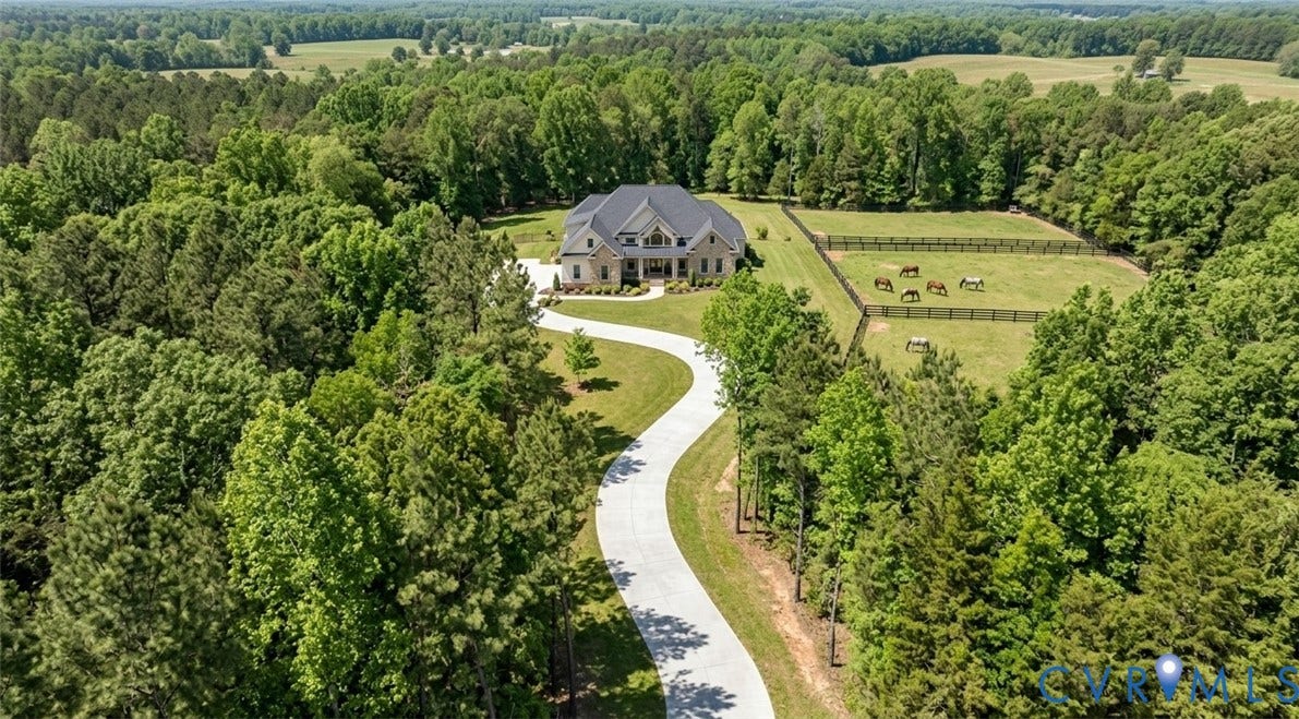 2580 Maidens Road, Maidens, Maidens, VA 23102 THIS IS A CONCEPT OF WHAT THE 6.836 ACRES COULD BE.Stone exterior residence with an expansive paved driveway, surrounded by mature trees, and featuring fenced pastures