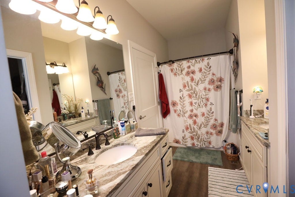 5670 Hickory Street, Powhatan, VA 23139 Bathroom featuring vanity, curtained shower, and dark wood-style floors