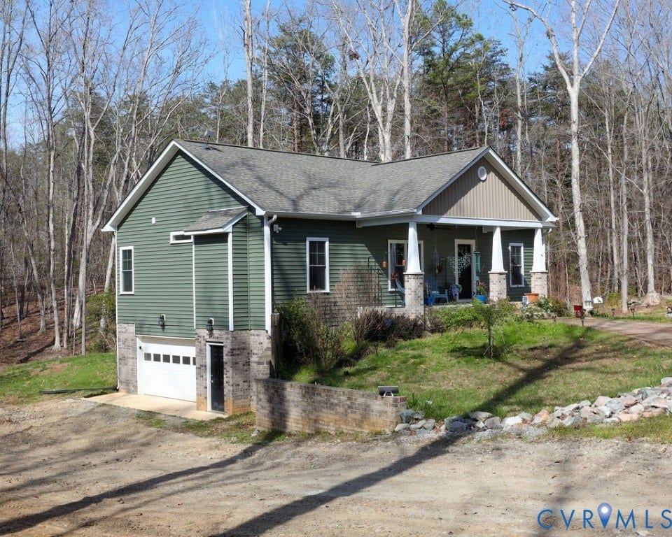 5670 Hickory Street, Powhatan, VA 23139 Craftsman house featuring an attached garage, a porch, driveway, roof with shingles, and a front lawn