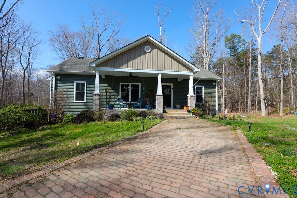 5670 Hickory Street, Powhatan, VA 23139 Craftsman-style house featuring covered porch, a front yard, and board and batten siding