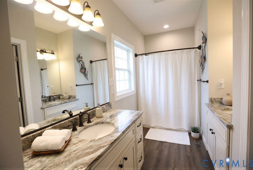 5670 Hickory Street, Powhatan, VA 23139 Full bathroom featuring two vanities, dark wood-style floors, and curtained shower