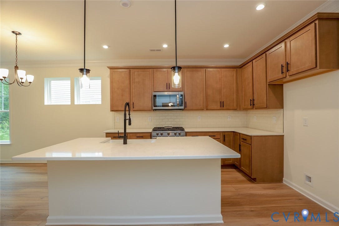6305 Lila Crest Lane, Cottages At Millwood, Chesterfield, VA 23112 The photo represents the plan, not the actual home. Design selections may vary. This home features a kitchen with a large island that elevates the look and the walk-in pantry.