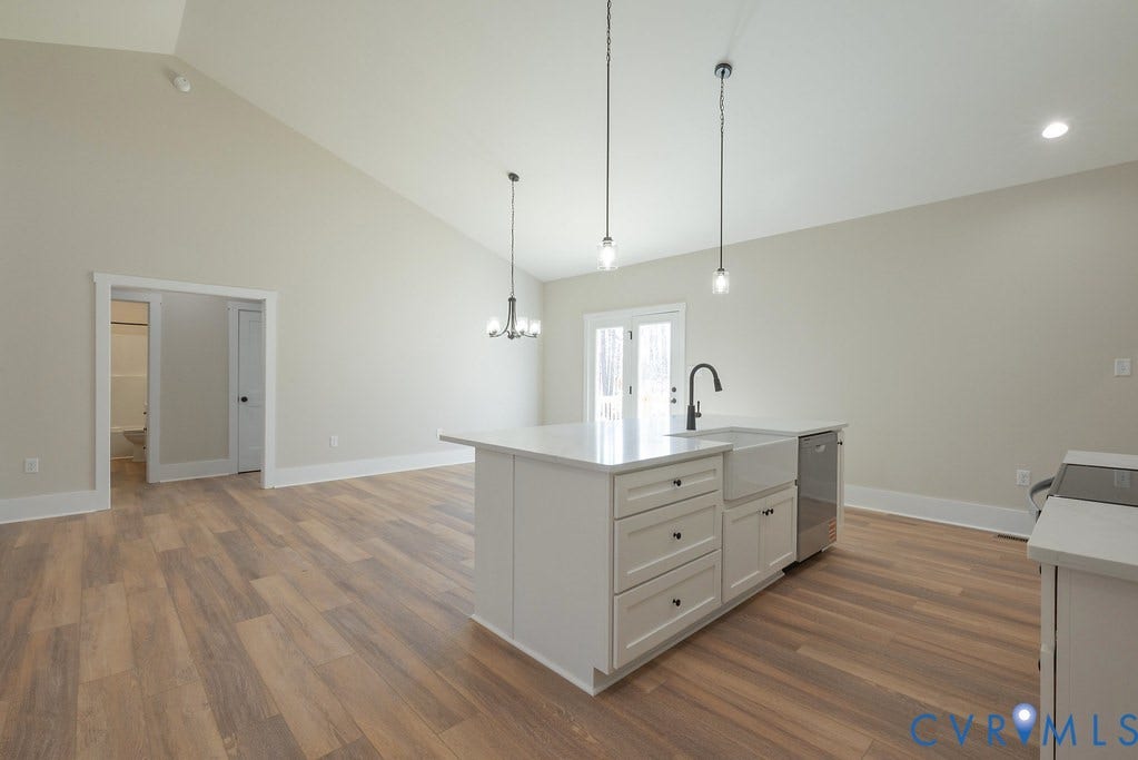 TBD Black Haw Lane, Hanover, VA 23059 Kitchen with white cabinets, a kitchen island with sink, suspended lighting, dark wood-style flooring, and lofted ceiling