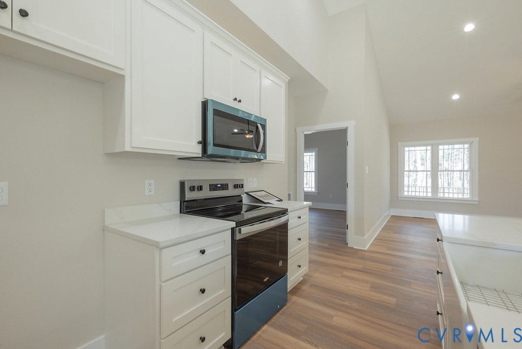 TBD Black Haw Lane, Hanover, VA 23059 Kitchen with stainless steel appliances, white cabinets, light wood-style flooring, recessed lighting, and vaulted ceiling