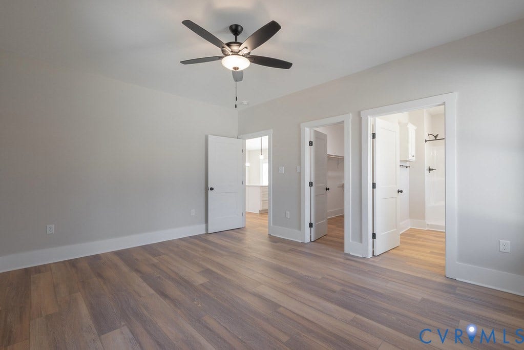 TBD Black Haw Lane, Hanover, VA 23059 Unfurnished bedroom featuring ensuite bath, ceiling fan, dark wood-style flooring, and a spacious closet