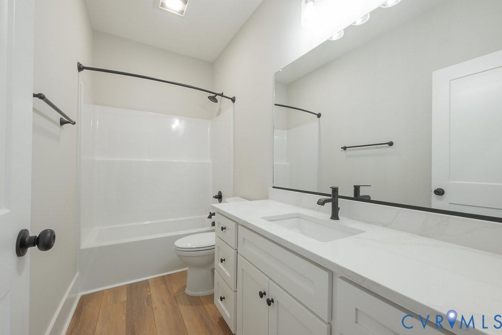TBD Black Haw Lane, Hanover, VA 23059 Full bathroom with vanity, dark wood finished floors, and bathing tub / shower combination