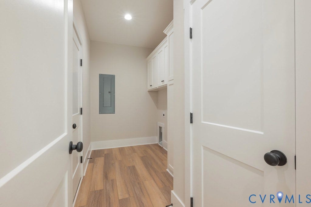 TBD Black Haw Lane, Hanover, VA 23059 Laundry room featuring light wood-type flooring, cabinet space, electric panel, electric dryer hookup, and recessed lighting
