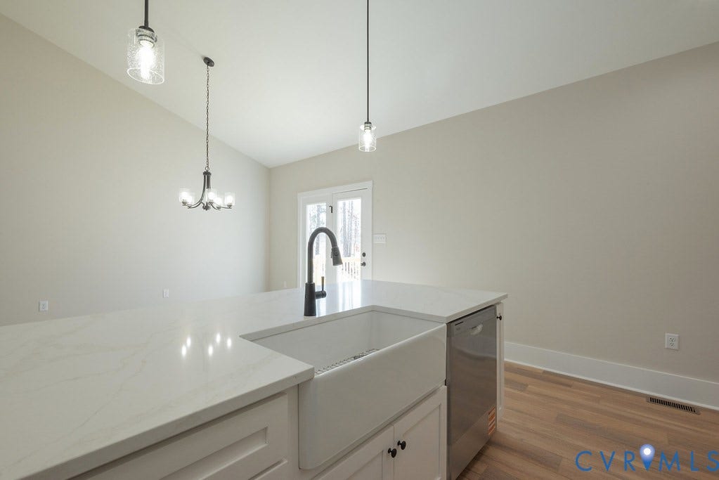 TBD Black Haw Lane, Hanover, VA 23059 Kitchen with vaulted ceiling, light stone counters, white cabinetry, stainless steel dishwasher, and dark wood finished floors