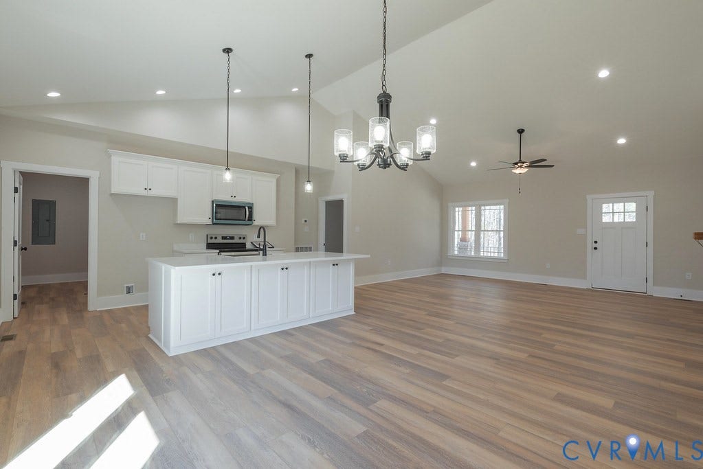 TBD Black Haw Lane, Hanover, VA 23059 Kitchen featuring open floor plan, suspended lighting, white cabinets, a kitchen island with sink, and light wood finished floors