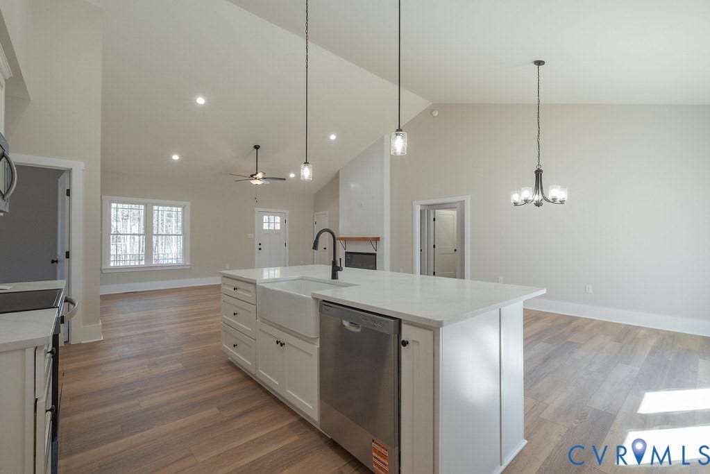 TBD Black Haw Lane, Hanover, VA 23059 Kitchen featuring open floor plan, white cabinets, stainless steel appliances, a center island with sink, and light stone counters