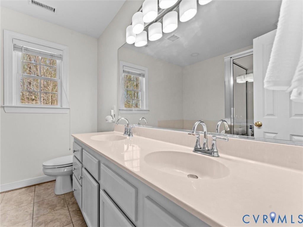 110 Oak Knoll Place, Bumpass, VA 23024 Tile flooring, double vanity with painted cabinetry