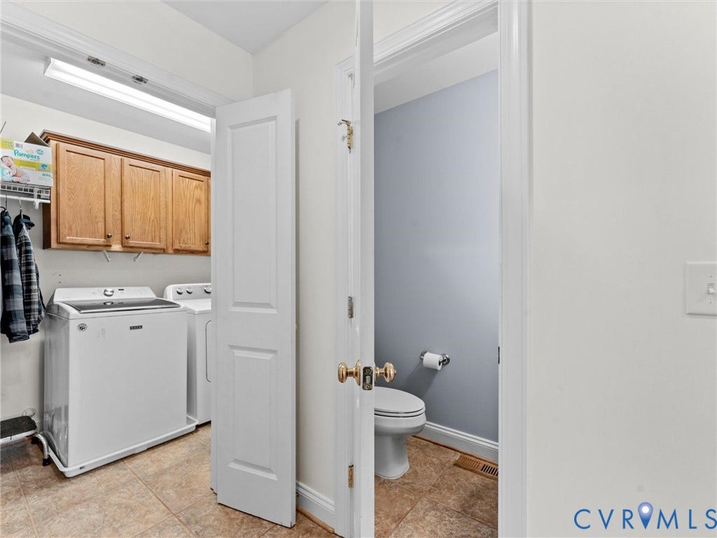 110 Oak Knoll Place, Bumpass, VA 23024 Utility passthrough with tile flooring, bath access, laundry, and closet storage