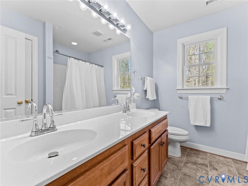 110 Oak Knoll Place, Bumpass, VA 23024 full hall bath with tile flooring, double vanity, linen closet, tub/shower combo