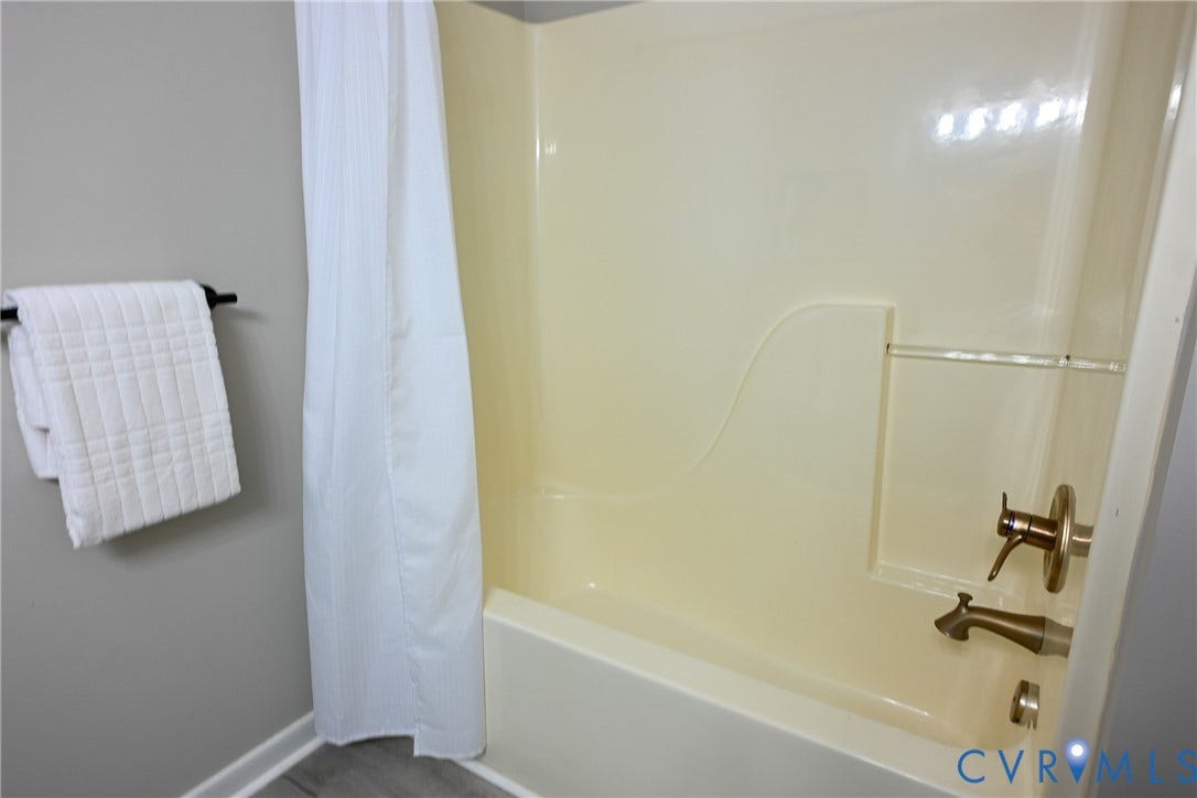 912 Harmony Road, Fairfield, VA 23059 Integrated bathtub and shower combination with bronze-finish fixtures