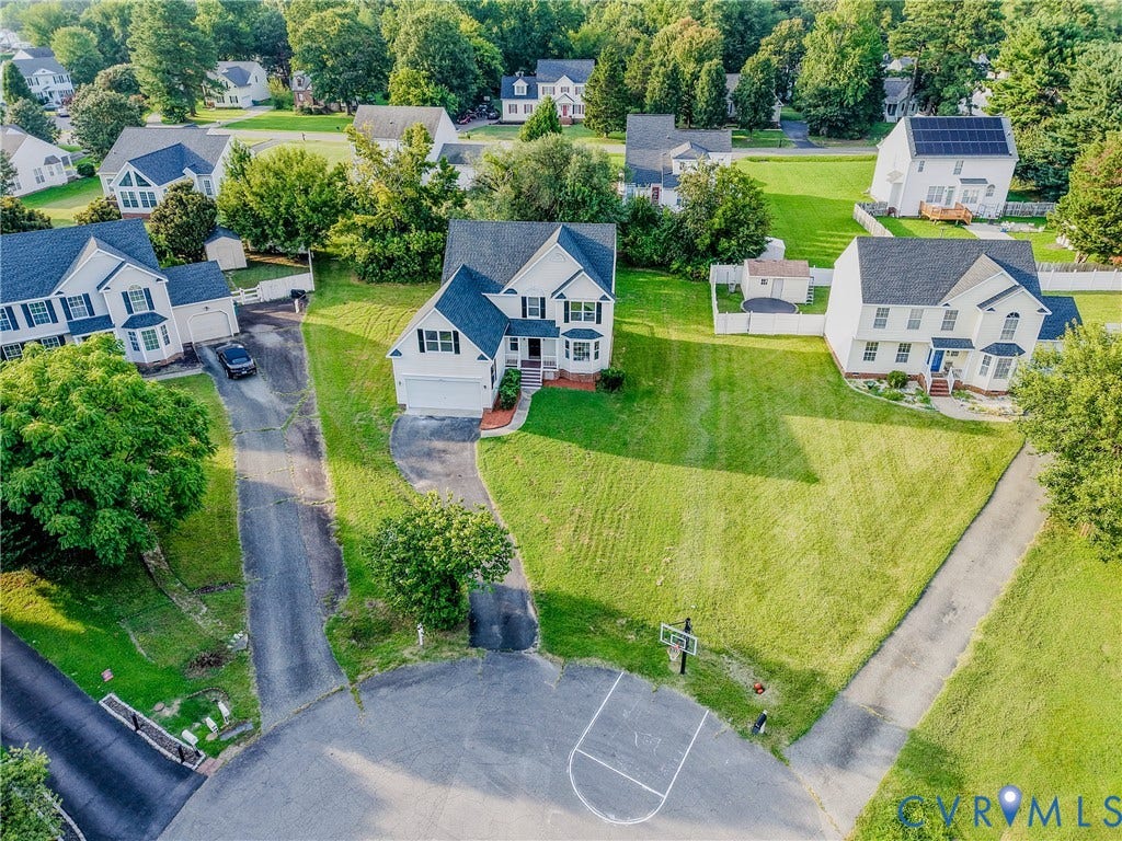 912 Harmony Road, Fairfield, VA 23059 White colonial-style home with a dark roof and a two-car garage