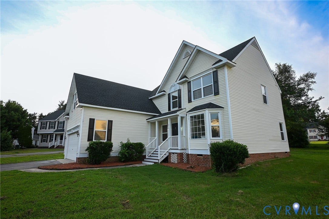 912 Harmony Road, Fairfield, VA 23059 Light-colored exterior siding with black shutters, dark asphalt shingle roof, integrated single-car garage, and a front bay window