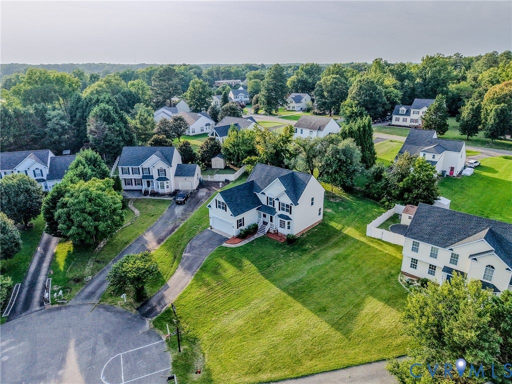 912 Harmony Road, Fairfield, VA 23059 Impressive Colonial-style residence set on expansive grounds featuring manicured lawns, mature landscaping, and established trees throughout the property