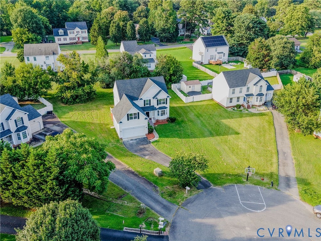 912 Harmony Road, Fairfield, VA 23059 Aerial view showcasing a two-story Colonial-style home with a two-car attached garage, situated on a manicured lot with mature landscaping