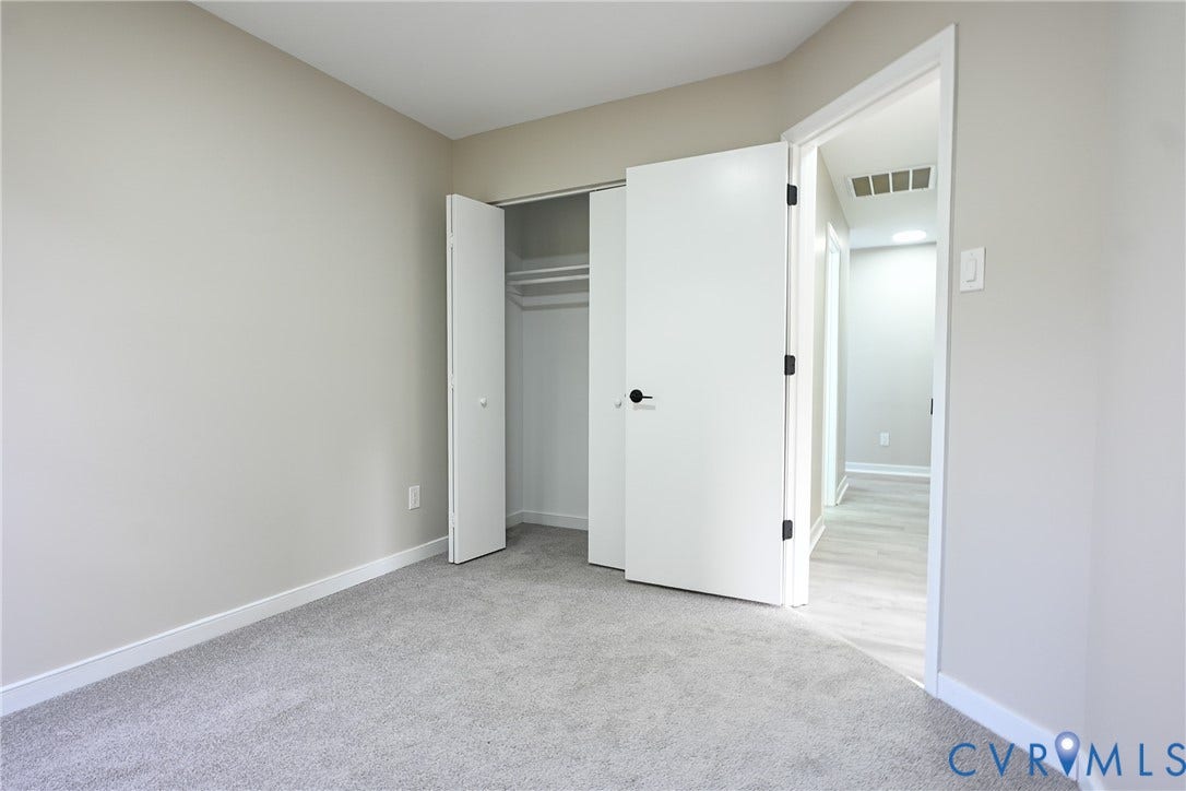 912 Harmony Road, Fairfield, VA 23059 Neutral wall tones, gray carpeting, white trim, and a bi-fold closet