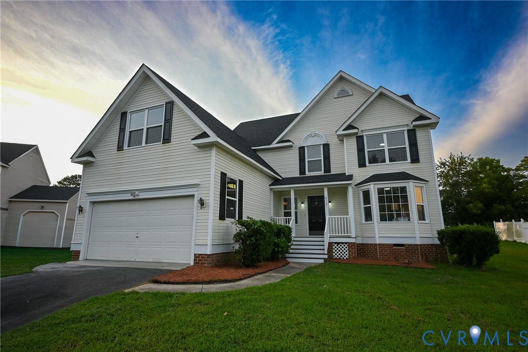 912 Harmony Road, Fairfield, VA 23059 Classic two-story Colonial featuring crisp white siding, multi-pane windows, and a welcoming front porch with columns