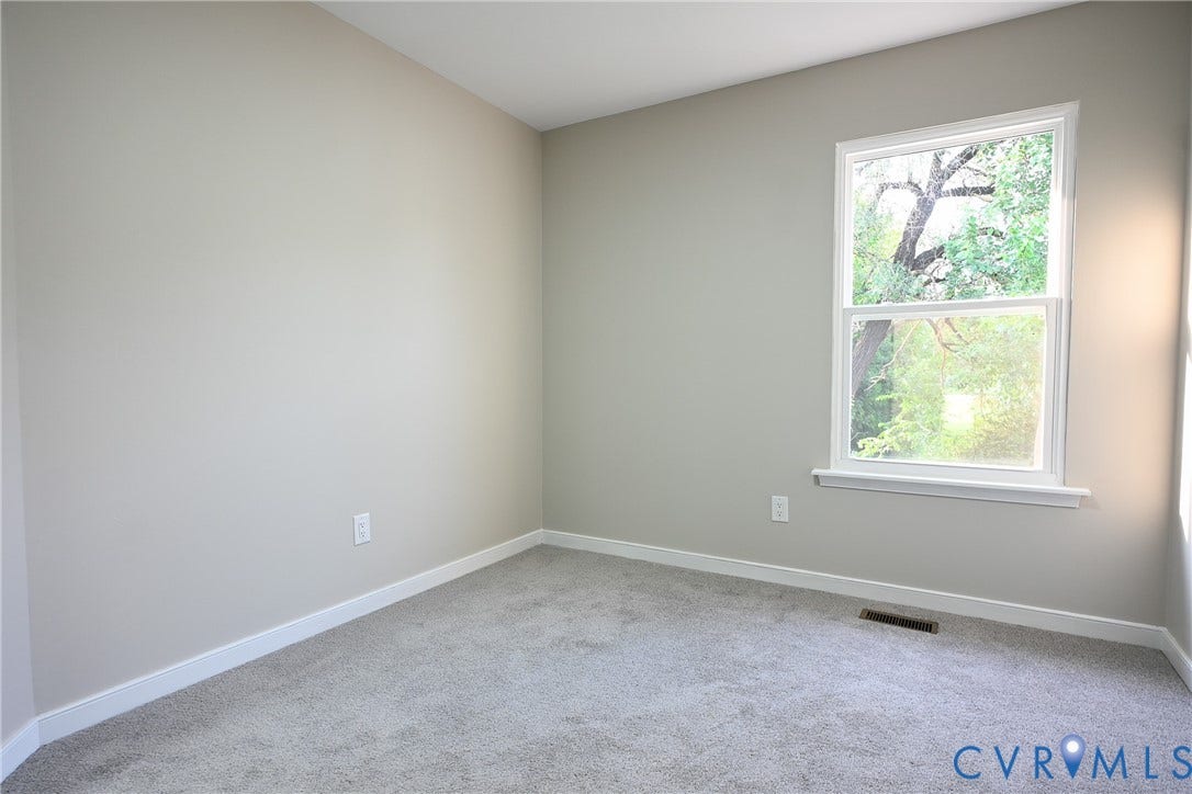 912 Harmony Road, Fairfield, VA 23059 Light grey wall paint, white trim, grey carpeting, and a double-hung window
