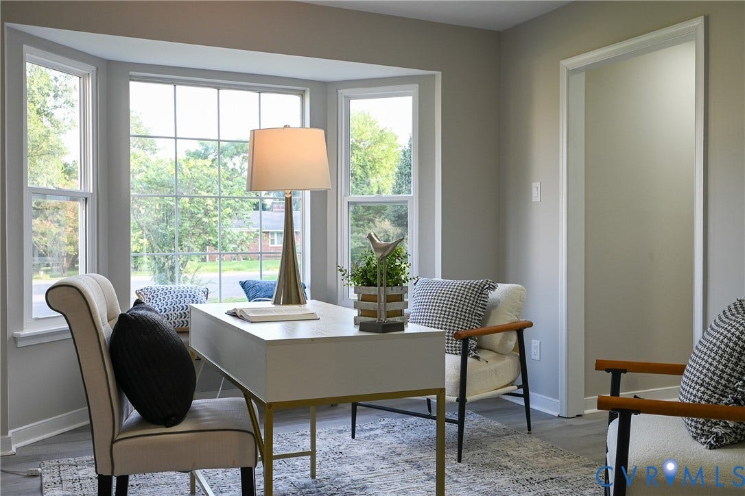 912 Harmony Road, Fairfield, VA 23059 Bright, light-filled home office featuring expansive multi-pane windows with natural outdoor scenery, neutral wall finishes, and hardwood flooring