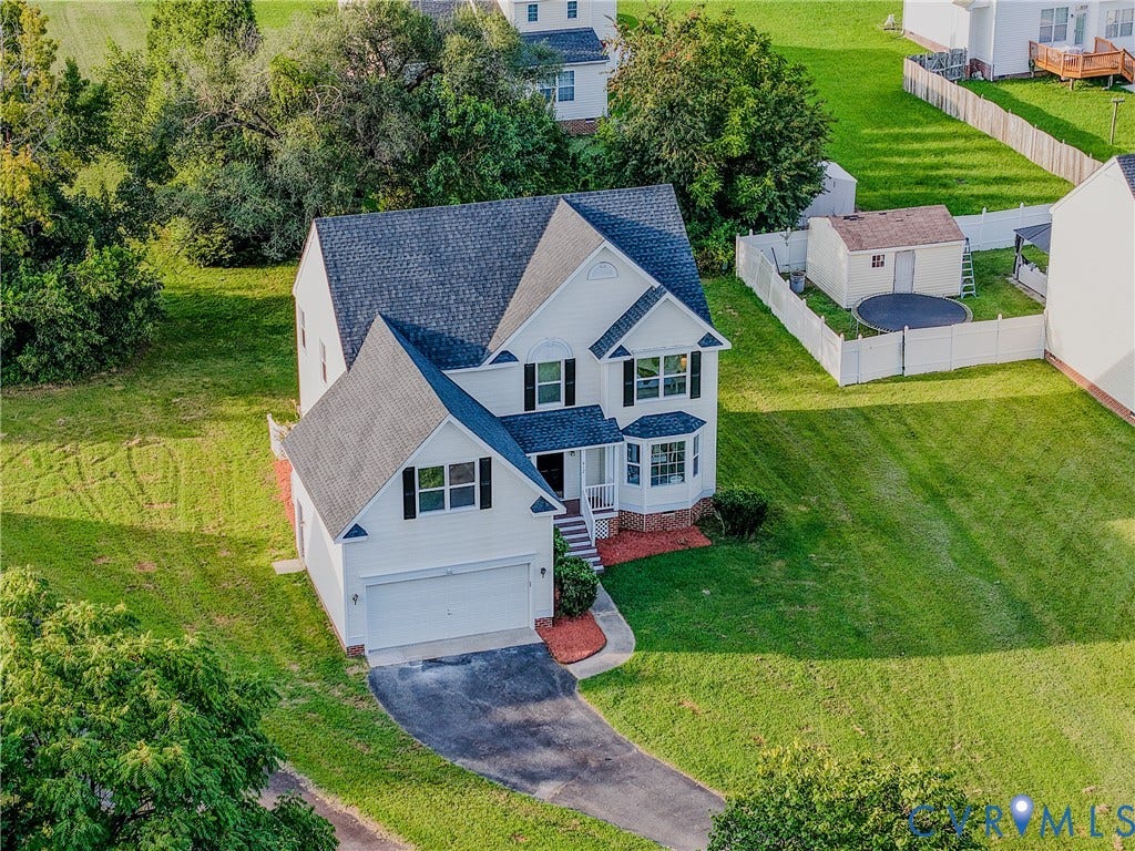 912 Harmony Road, Fairfield, VA 23059 White multi-story residence with a dark shingle roof, attached two-car garage, and a curved paved driveway