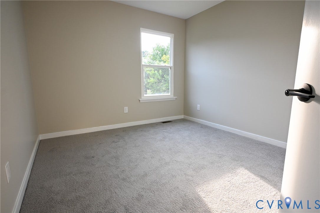 912 Harmony Road, Fairfield, VA 23059 Wall-to-wall carpeting, neutral wall color, and a single-hung window with white trim