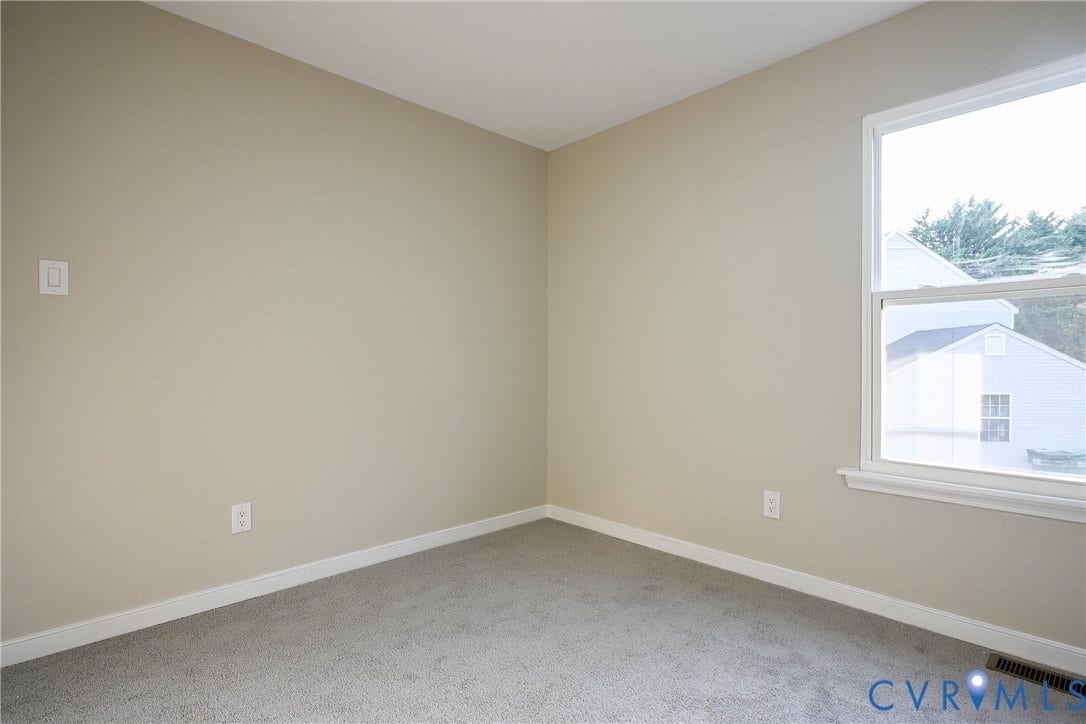 912 Harmony Road, Fairfield, VA 23059 Neutral wall tones, gray carpeting, white trim, and a white-framed window