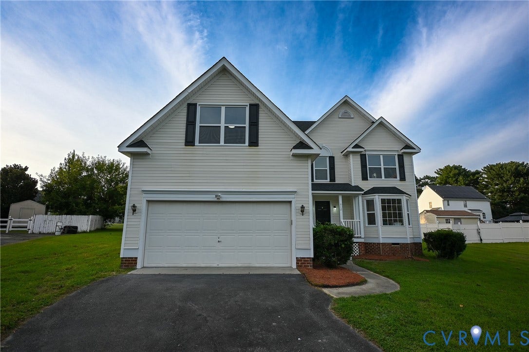 912 Harmony Road, Fairfield, VA 23059 Two-story residence featuring light-colored siding, a two-car garage, and multiple gables