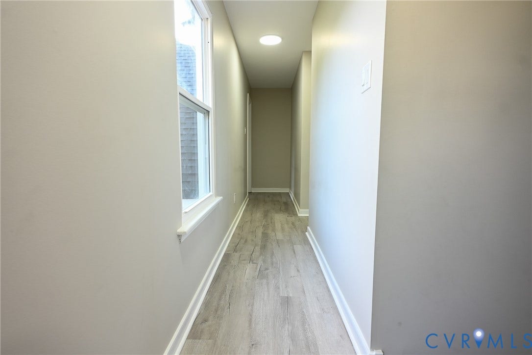 912 Harmony Road, Fairfield, VA 23059 Bright hallway featuring wood-finish flooring, recessed ceiling lighting, and large window with natural light
