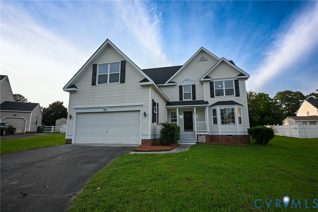 912 Harmony Road, Fairfield, VA 23059 Classic two-story Colonial featuring crisp white siding, a two-car attached garage, and a gabled roofline with multiple peaks