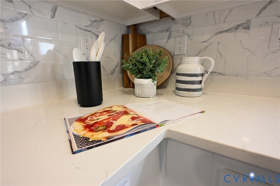 912 Harmony Road, Fairfield, VA 23059 White countertop surfaces, white subway tile backsplash with marbling, and white cabinetry