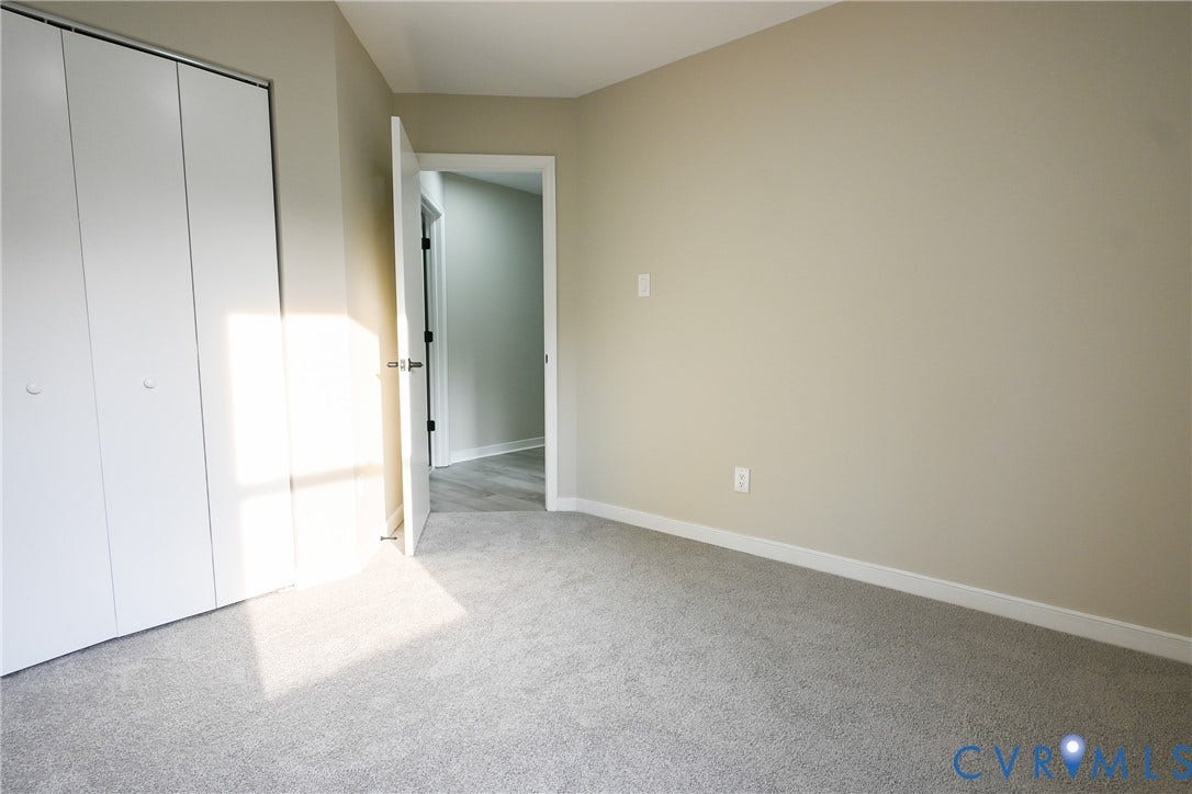 912 Harmony Road, Fairfield, VA 23059 Neutral wall color, light gray carpeting, and white bi-fold closet doors