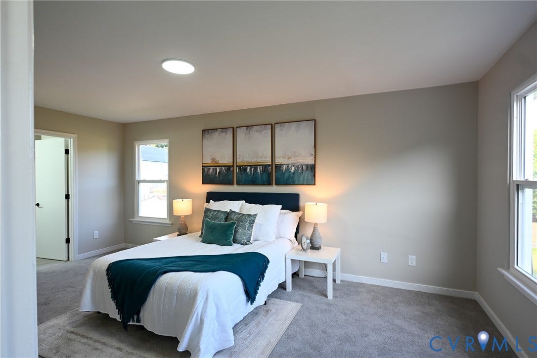 912 Harmony Road, Fairfield, VA 23059 Recessed ceiling light, two windows with white trim, gray carpet, light gray wall paint, and a white interior door with black hardware