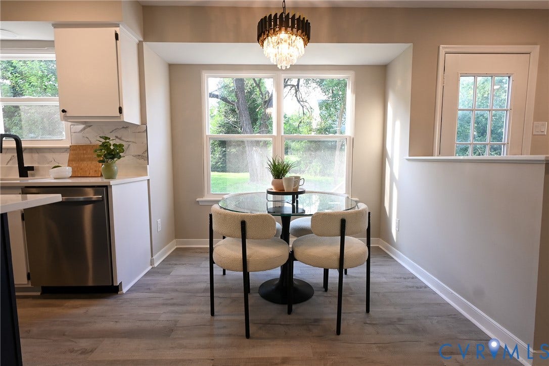 912 Harmony Road, Fairfield, VA 23059 Kitchen area featuring wood-finish flooring, white cabinetry, a built-in stainless steel dishwasher, and a decorative chandelier