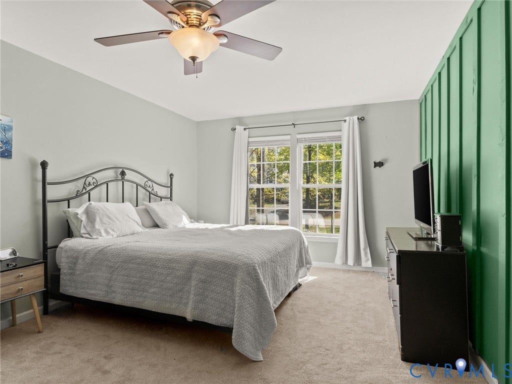 126 Reedy Creek Road, Reedy Creek, Louisa, VA 23093 Bedroom featuring a window with white curtains, a ceiling fan, and carpeted flooring