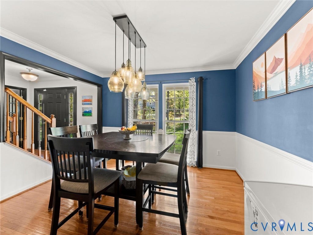 126 Reedy Creek Road, Reedy Creek, Louisa, VA 23093 The property features hardwood floors, white crown molding, and a light fixture with multiple glass pendants over the table