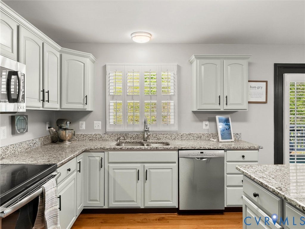 126 Reedy Creek Road, Reedy Creek, Louisa, VA 23093 The kitchen features ample cabinetry, speckled countertops, and stainless steel appliances
