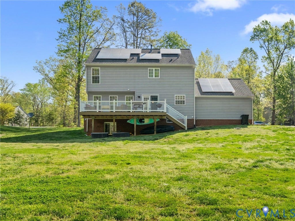 126 Reedy Creek Road, Reedy Creek, Louisa, VA 23093 The property features a large grassy yard with mature trees