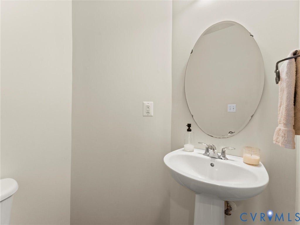126 Reedy Creek Road, Reedy Creek, Louisa, VA 23093 Bathroom with a white pedestal sink, chrome faucet, and an oval mirror