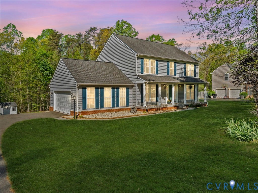 126 Reedy Creek Road, Reedy Creek, Louisa, VA 23093 Two-story colonial residence featuring grey siding, a covered front porch with white columns, and a two-car attached garage